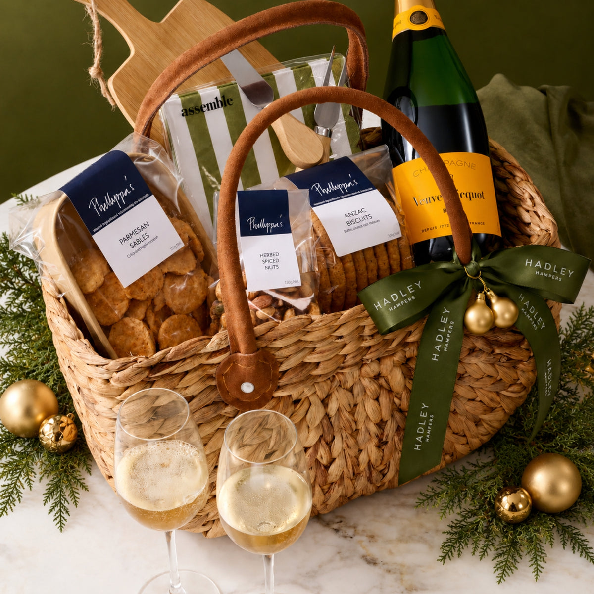 The Christmas Host hamper with Veuve Clicquot Champagne, gourmet treats and entertaining essentials in a woven basket