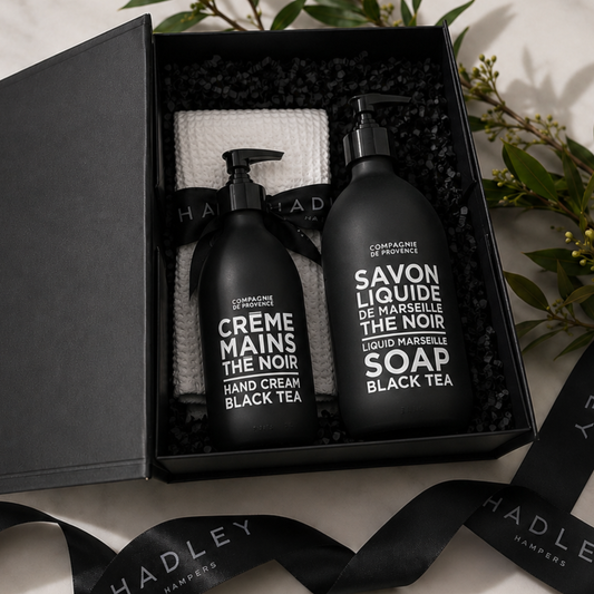 The Refined Essentialist hand care gift hamper with Compagnie de Provence Black Tea soap, hand cream and white waffle towel