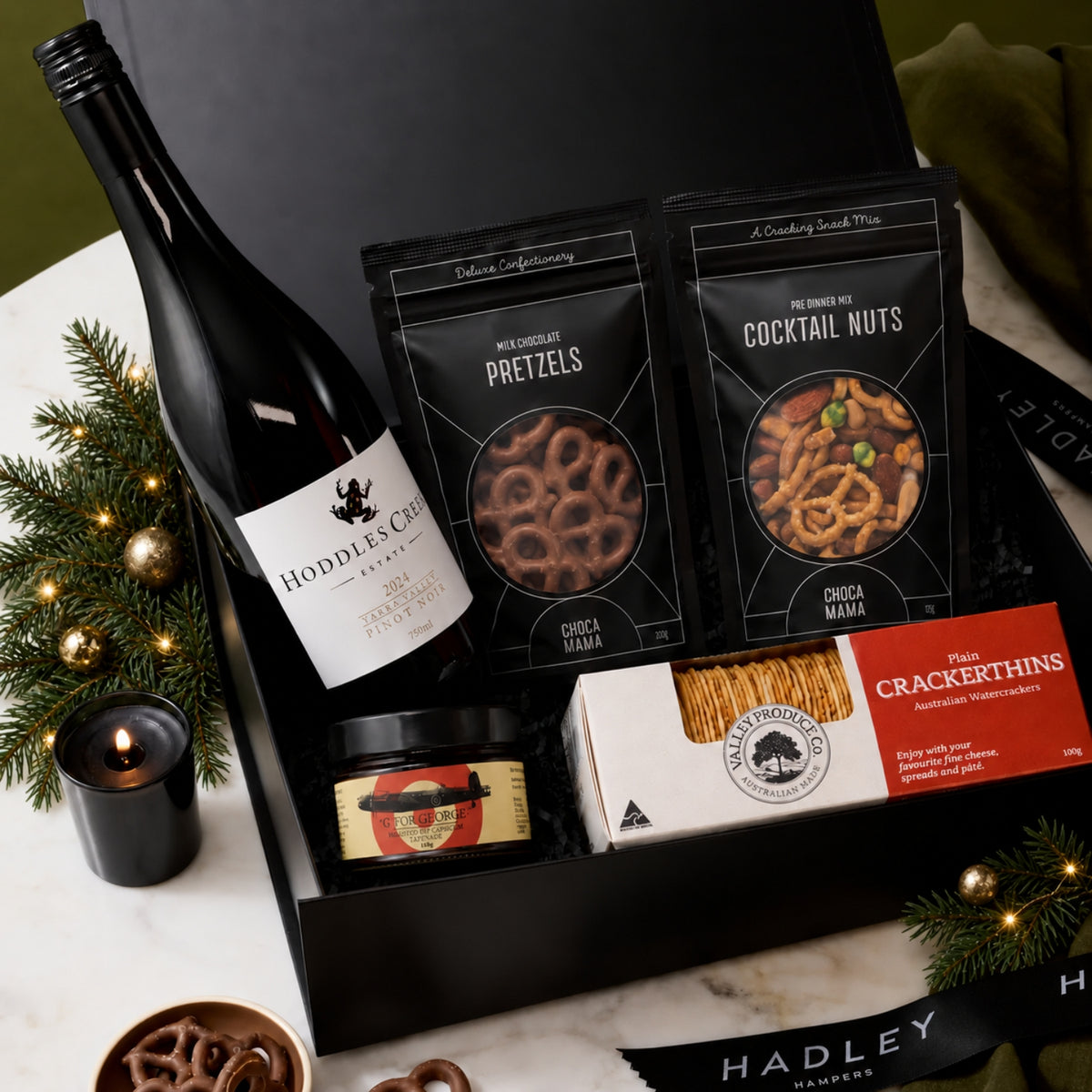 Christmas Pinot Noir gift hamper with Hoddles Creek Estate wine, crackers, tapenade, cocktail nuts and milk chocolate pretzels.