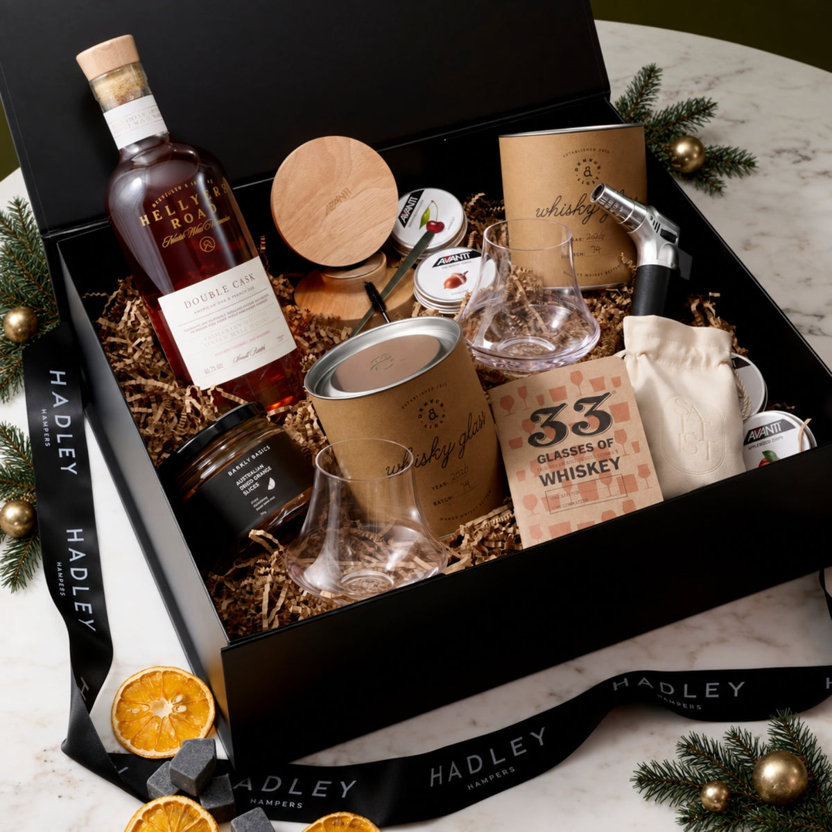 The Christmas Whisky Connoisseur hamper with Hellyers Road Double Cask, two whisky glasses, stones and a smoked cocktail kit
